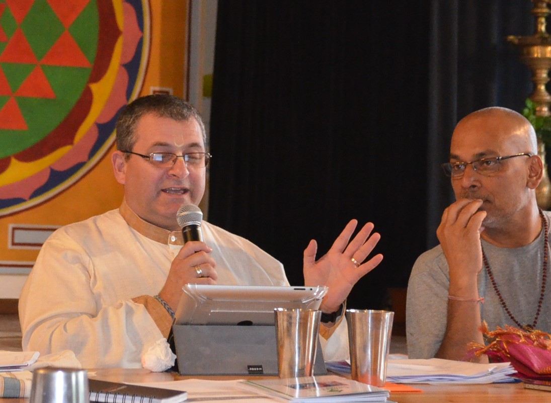 Mahaprabhu Das (left) speaks at the Hindu Forum of Europe General Assembly, as HFE president Radj Bhondoe (right) listens